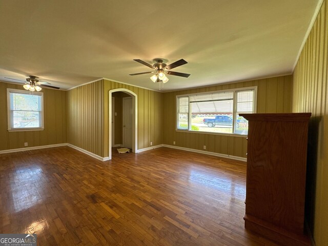 86 Empire St, Yatesville, GA 31097 - empty room with arched walkways, dark wood-type flooring, and ceiling fan