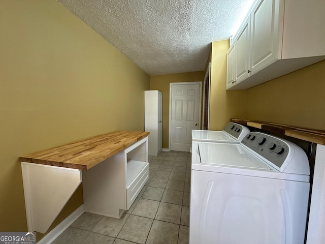 86 Empire St, Yatesville, GA 31097 - laundry area featuring baseboards, separate washer and dryer, a textured ceiling, cabinet space, and light tile patterned flooring