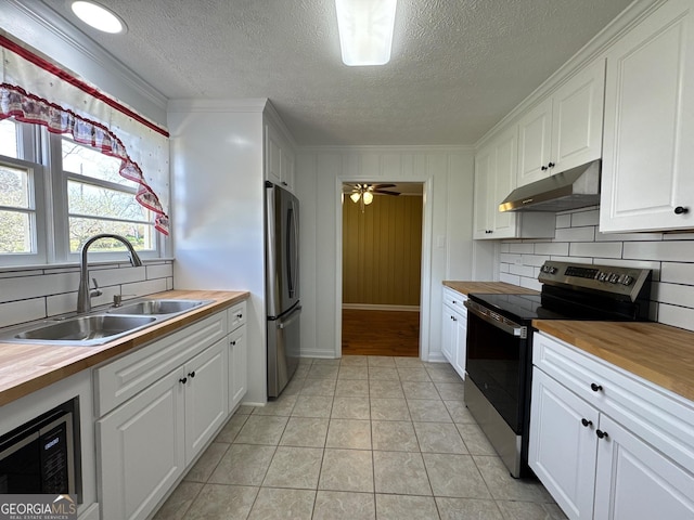 86 Empire St, Yatesville, GA 31097 - kitchen featuring white cabinetry, appliances with stainless steel finishes, under cabinet range hood, a sink, and wood counters
