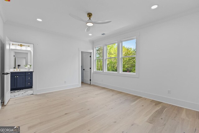 unfurnished bedroom with a sink, ornamental molding, light wood finished floors, and recessed lighting