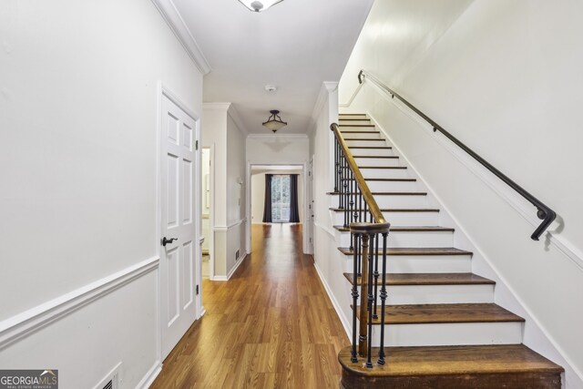45 Willow Gln NE, Atlanta, GA 30342 - foyer entrance with visible vents, baseboards, crown molding, stairway, and wood finished floors
