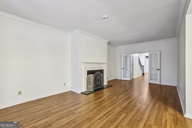 45 Willow Gln NE, Atlanta, GA 30342 - unfurnished living room featuring wood finished floors, baseboards, ornamental molding, and a fireplace with raised hearth