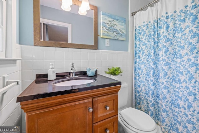 full bathroom with a shower with shower curtain, toilet, tile walls, vanity, and wainscoting