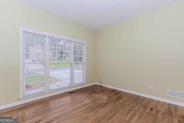 4106 Creekview Ridge Dr NE, Buford, GA 30518 - unfurnished living room with a fireplace, wood finished floors, a high ceiling, and a ceiling fan