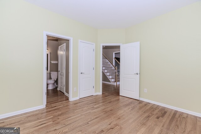4106 Creekview Ridge Dr NE, Buford, GA 30518 - unfurnished living room with ceiling fan, baseboards, and light wood finished floors