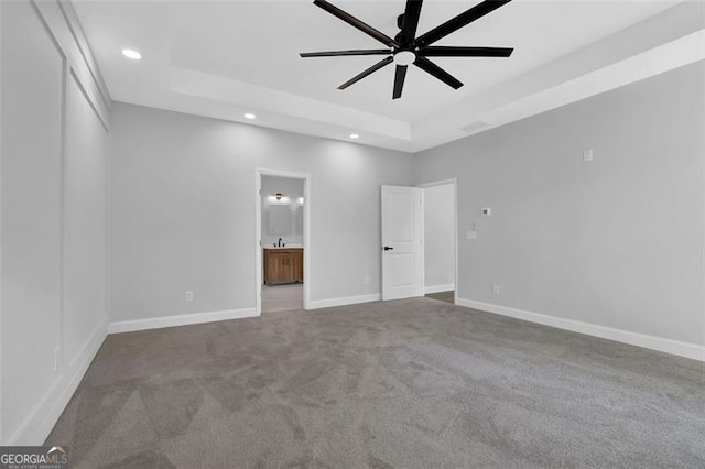 5719 Calm Valley Pt, Flowery Branch, GA 30542 - unfurnished bedroom with a tray ceiling, recessed lighting, carpet, ensuite bathroom, and ceiling fan
