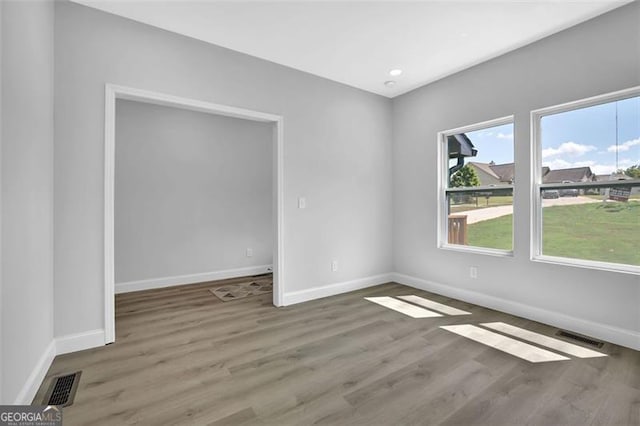 5719 Calm Valley Pt, Flowery Branch, GA 30542 - empty room with wood finished floors and recessed lighting