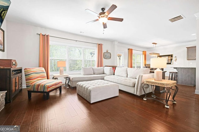 living area with dark wood-style flooring, visible vents, and a ceiling fan
