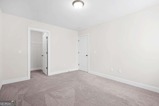 empty room with baseboards and carpet flooring