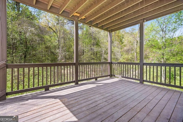 wooden deck featuring a view of trees