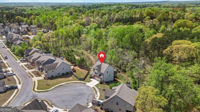bird's eye view featuring a view of trees and a residential view