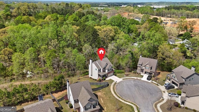 drone / aerial view with a forest view and a residential view