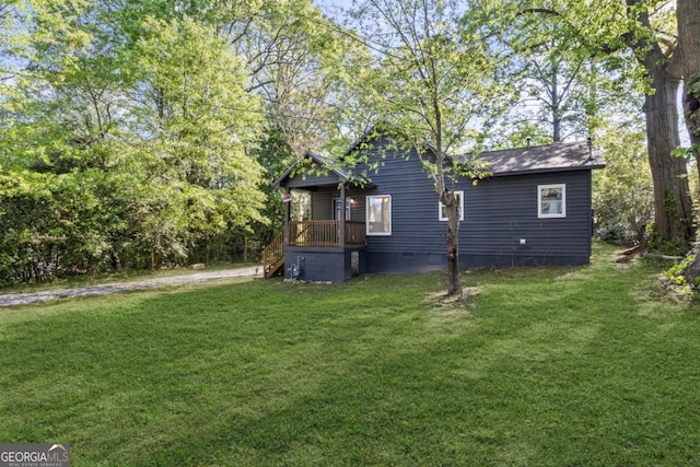 exterior space featuring crawl space and a lawn