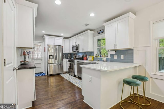 952 Columbia Dr, Decatur, GA 30030 - kitchen with stainless steel appliances, healthy amount of natural light, backsplash, and recessed lighting