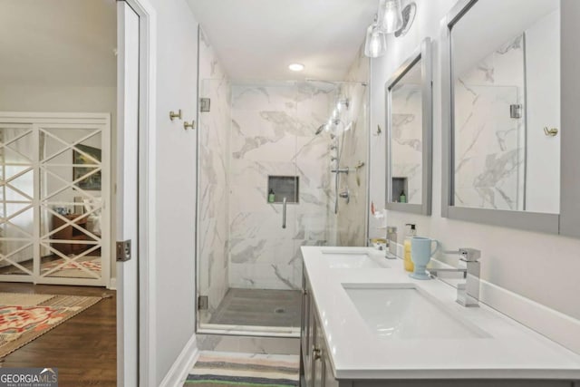 952 Columbia Dr, Decatur, GA 30030 - bathroom featuring a marble finish shower, double vanity, recessed lighting, and wood finished floors