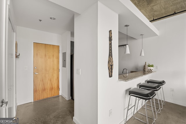 interior space with baseboards and concrete flooring