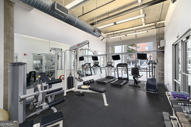 exercise room with a towering ceiling