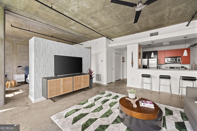 living area with visible vents, baseboards, and ceiling fan