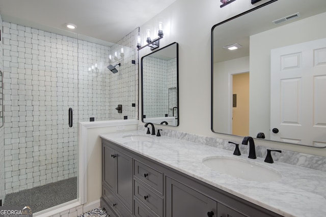 full bath with a sink, visible vents, double vanity, and a stall shower