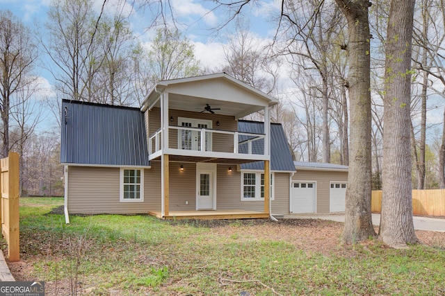 view of front of property with metal roof, a balcony, an attached garage, and ceiling fan