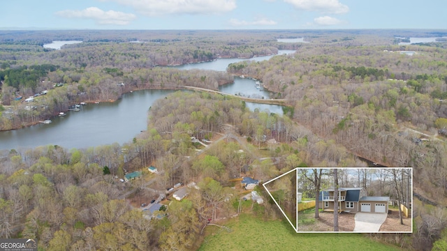 aerial view featuring a water view and a view of trees