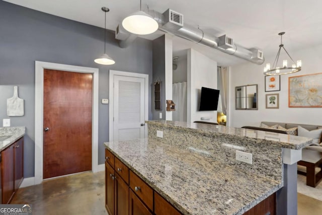 791 Wylie St SE Unit 1111, Atlanta, GA 30316 - kitchen featuring finished concrete flooring, visible vents, a chandelier, light stone counters, and open floor plan