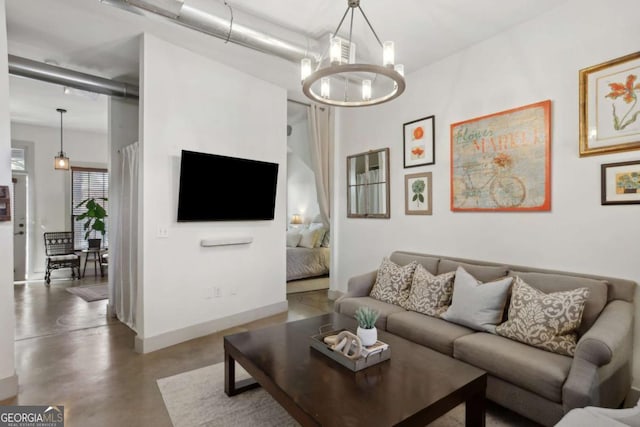 791 Wylie St SE Unit 1111, Atlanta, GA 30316 - living room featuring a notable chandelier, baseboards, and concrete flooring