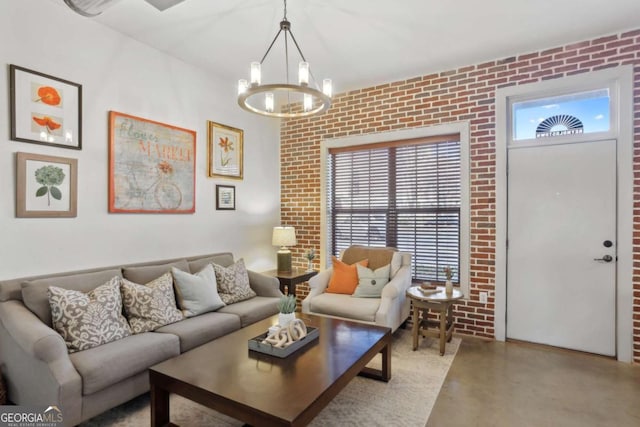791 Wylie St SE Unit 1111, Atlanta, GA 30316 - living room featuring brick wall, concrete floors, and a notable chandelier