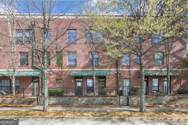 791 Wylie St SE Unit 1111, Atlanta, GA 30316 - view of building exterior with a fenced front yard