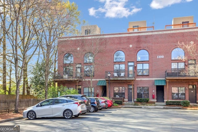 791 Wylie St SE Unit 1111, Atlanta, GA 30316 - view of building exterior with uncovered parking and fence
