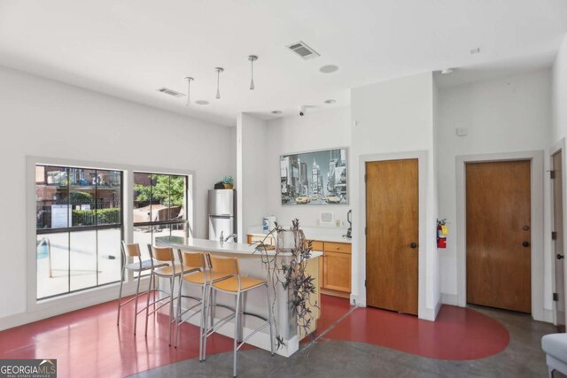 791 Wylie St SE Unit 1111, Atlanta, GA 30316 - kitchen featuring concrete flooring, visible vents, and freestanding refrigerator