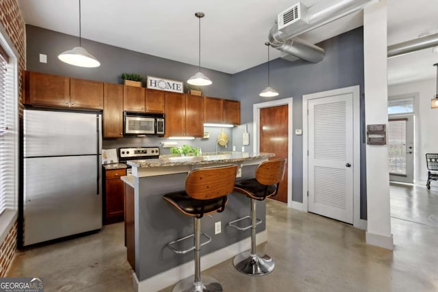 791 Wylie St SE Unit 1111, Atlanta, GA 30316 - kitchen with a kitchen breakfast bar, concrete floors, a towering ceiling, appliances with stainless steel finishes, and brown cabinets