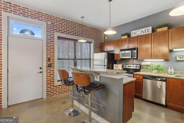 791 Wylie St SE Unit 1111, Atlanta, GA 30316 - kitchen with stainless steel appliances, concrete floors, a breakfast bar area, and brick wall