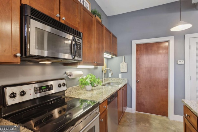 791 Wylie St SE Unit 1111, Atlanta, GA 30316 - kitchen with baseboards, light stone countertops, brown cabinetry, appliances with stainless steel finishes, and a sink