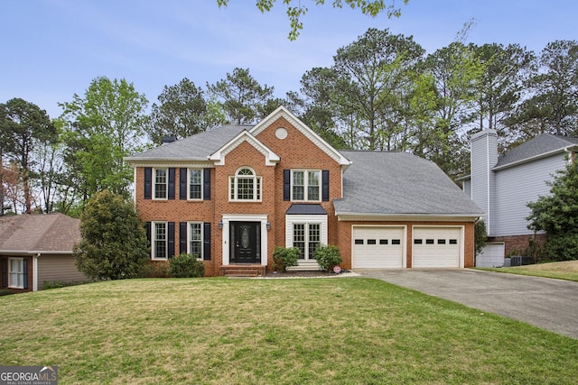 4284 Windy Gap Ct NW, Kennesaw, GA 30144 - colonial-style house featuring a garage, driveway, a front lawn, and brick siding