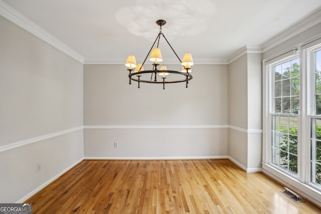 4284 Windy Gap Ct NW, Kennesaw, GA 30144 - unfurnished room featuring wood finished floors, a notable chandelier, ornamental molding, and visible vents