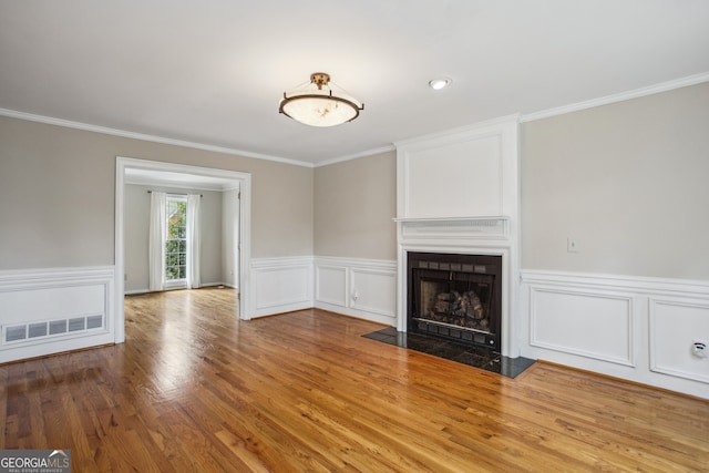 4284 Windy Gap Ct NW, Kennesaw, GA 30144 - unfurnished living room with crown molding, wood finished floors, a large fireplace, and visible vents