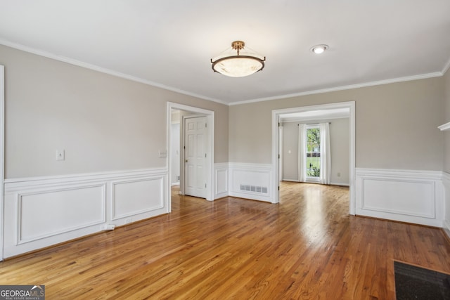 4284 Windy Gap Ct NW, Kennesaw, GA 30144 - spare room featuring crown molding, light wood finished floors, wainscoting, and visible vents