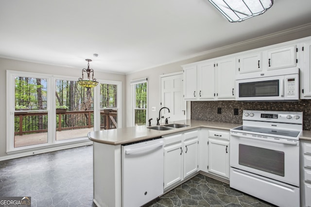 4284 Windy Gap Ct NW, Kennesaw, GA 30144 - kitchen with white appliances, a peninsula, crown molding, white cabinets, and a sink