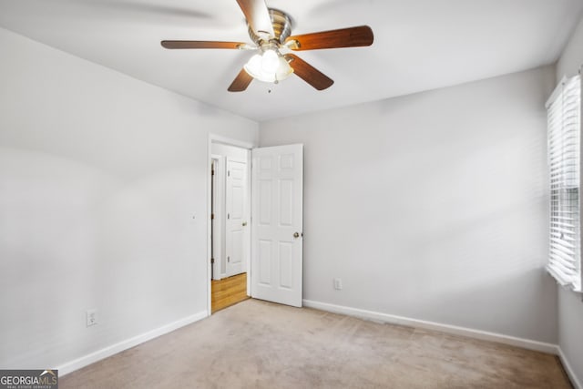 4284 Windy Gap Ct NW, Kennesaw, GA 30144 - carpeted spare room featuring baseboards, a ceiling fan, and a healthy amount of sunlight