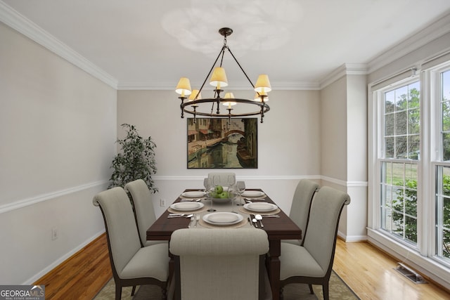 4284 Windy Gap Ct NW, Kennesaw, GA 30144 - dining area featuring a chandelier, wood finished floors, and crown molding