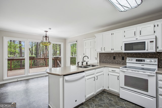 4284 Windy Gap Ct NW, Kennesaw, GA 30144 - kitchen featuring white appliances, crown molding, a peninsula, white cabinetry, and decorative backsplash