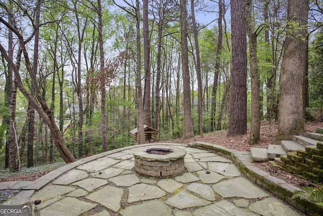 4284 Windy Gap Ct NW, Kennesaw, GA 30144 - view of patio with a wooded view and a fire pit
