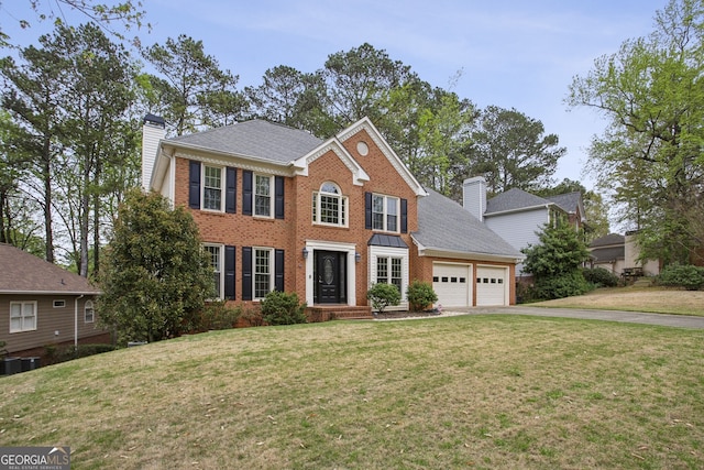 4284 Windy Gap Ct NW, Kennesaw, GA 30144 - colonial home featuring brick siding, an attached garage, driveway, and a chimney