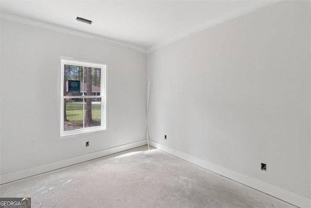 spare room featuring visible vents, baseboards, and concrete flooring