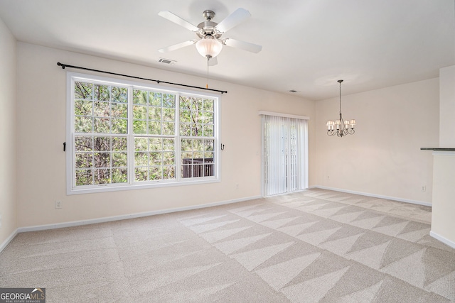 empty room featuring baseboards, visible vents, and light carpet