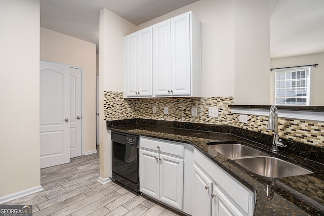 kitchen with a sink, light wood finished floors, black dishwasher, and white cabinetry