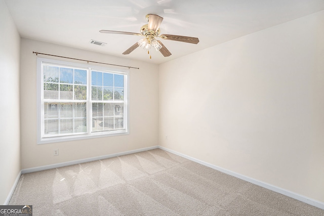 unfurnished room featuring visible vents, carpet, and baseboards