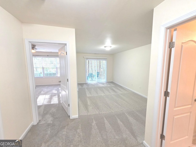 interior space with baseboards and carpet flooring
