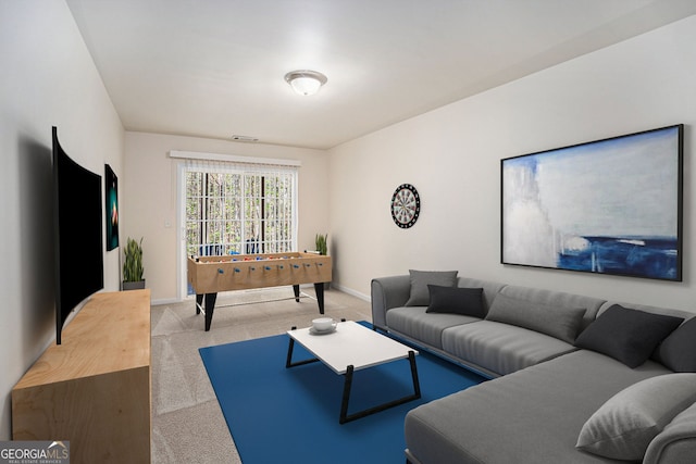 carpeted living area featuring baseboards and visible vents